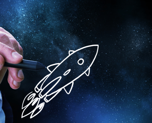 hand drawing a rocket ship zooming across space